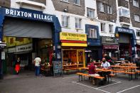 Empty tables are seen during a quiet night at Brixton Village in London