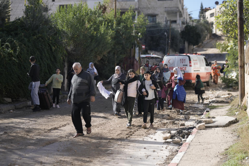 Palestinians flee an Israeli military raid on Jenin refugee camp in the West Bank on Wednesday, Nov. 29, 2023. (AP Photo/Majdi Mohammed)