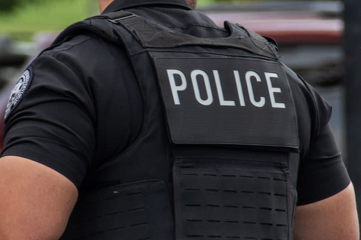 A police officer's back is shown with the word "POLICE" visible on their vest. The article is categorized as Internet Finds