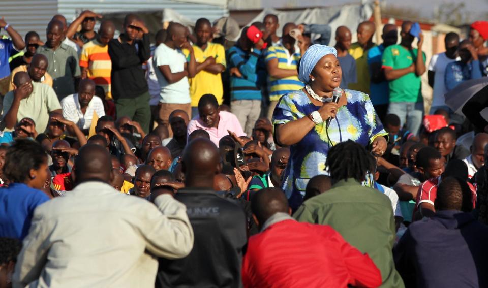 South Africa's Minister of Defence Nosiviwe Mapisa-Nqakula addresses mine workers at the Lonmin mine near Rustenburg, South Africa, Tuesday, Aug. 21, 2012. Miners Workers trickled in Tuesday at the Lonmin platinum mine where 44 people have died in a wildcat strike, as South Africa urged the company to suspend an ultimatum to return to work. (AP Photo/Themba Hadebe)