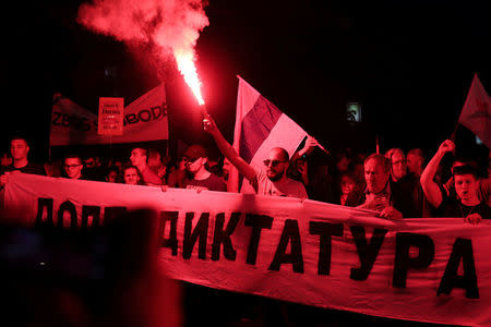 A protester lights a flare during a protest against Prime Minister Aleksandar Vucic's government in Belgrade, Serbia April 25, 2017. REUTERS/Marko Djurica