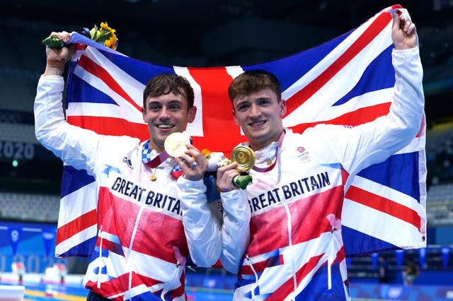 Tom Daley (left) and Matty Lee show off their Olympic gold medals while holding a Union flag