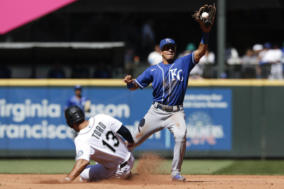 Kansas City Royals shortstop Nicky Lopez gets Seattle Mariners' Abraham Toro on a force out during the third inning of a baseball game Saturday, Aug. 28, 2021, in Seattle. (AP Photo/Jason Redmond)