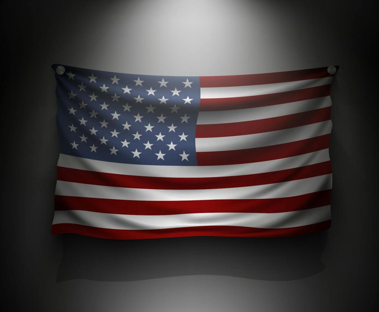 Democracy in the U.S. has historically not been available to all. <a href="https://www.gettyimages.com/detail/illustration/waving-flag-united-states-on-a-dark-wall-royalty-free-illustration/513437560?phrase=democracy+united+states&adppopup=true" rel="nofollow noopener" target="_blank" data-ylk="slk:Panacea Doll/iStock / Getty Images Plus;elm:context_link;itc:0;sec:content-canvas" class="link ">Panacea Doll/iStock / Getty Images Plus</a>