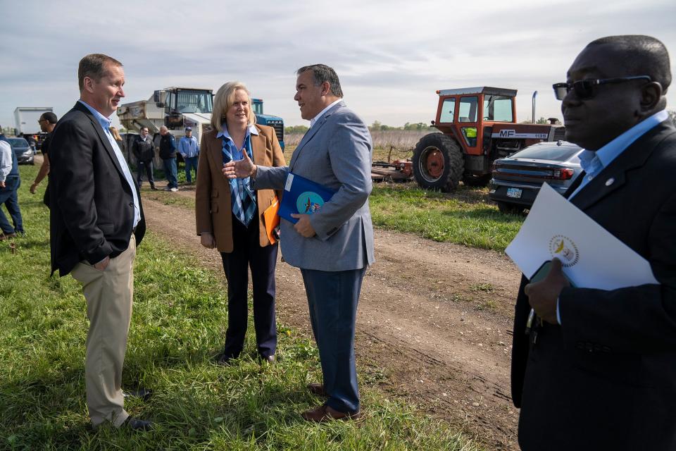 Columbus Mayor Andrew J. Ginther, center, speaks with Kristen Atha, director of the Department of Public Utilities, and Brian Haemmerle from the Columbus Division of Water before a ceremony to recognize the construction of a new solar project on Parsons Avenue. It's one of two new solar projects that will provide 45 MW of additional clean energy to Division of Power customers.