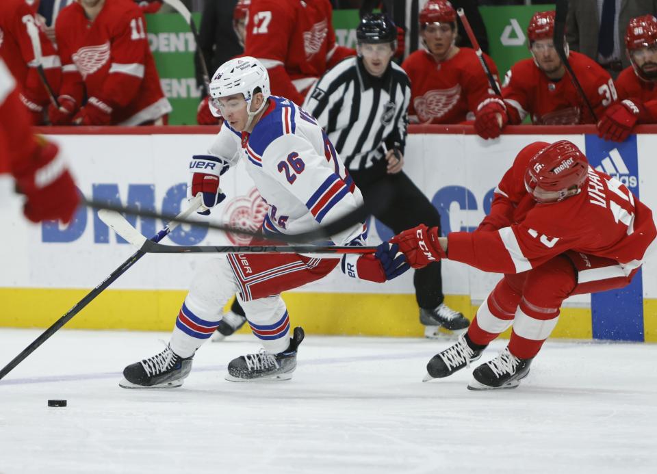 Detroit Red Wings left wing Jakub Vrana (15) defends against New York Rangers left wing Jimmy Vesey (26) during the third period of an NHL hockey game Thursday, Feb. 23, 2023, in Detroit. (AP Photo/Duane Burleson)