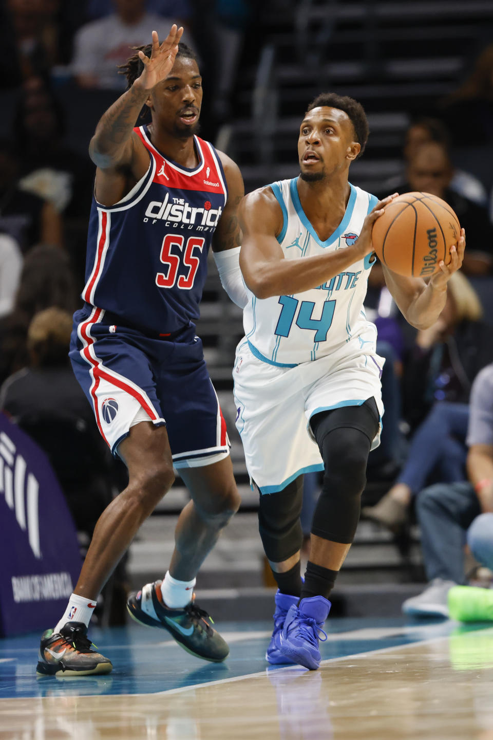 Charlotte Hornets guard Ish Smith (14) looks to pass against Washington Wizards guard Delon Wright (55) during the first half of an NBA basketball game in Charlotte, N.C., Wednesday, Nov. 8, 2023. (AP Photo/Nell Redmond)