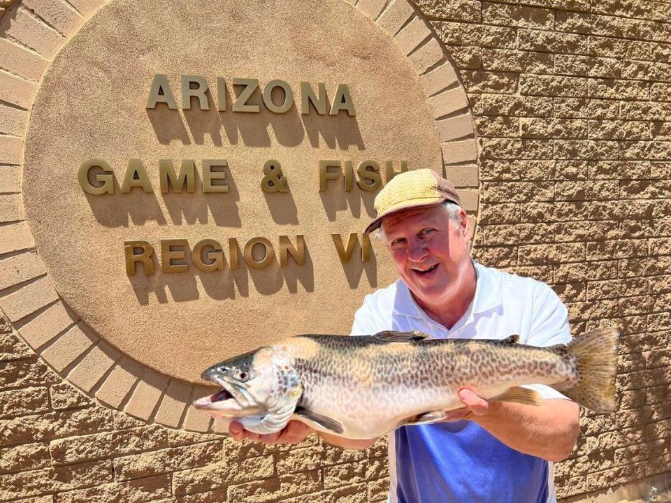 Carl Erickson is seen holding a record-breaking tiger trout. He caught the fish June 22 from the Woods Canyon Lake near Payson, Arizona.