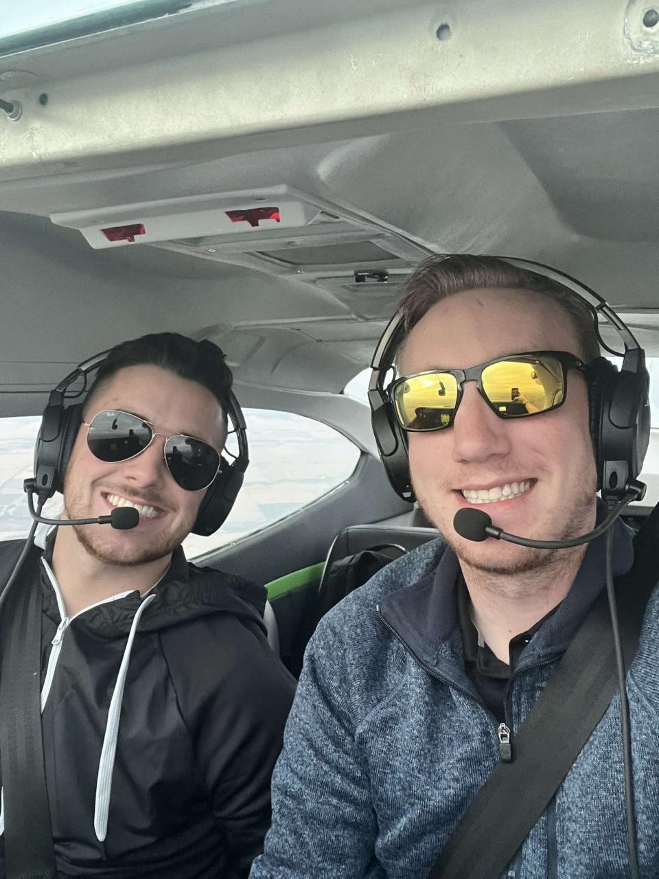 Former Garmin interns Ethan Stubbs (left) and AJ Luinstra (right) fly a plane. The two were hired full time by Garmin following their internships.