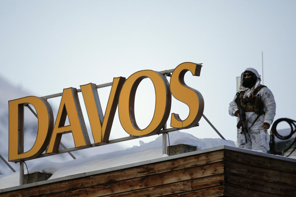 A police security guard patrols on the roof of a hotel ahead of the World Economic Forum in Davos, Switzerland, Monday, Jan. 20, 2020. The 50th annual meeting of the forum will take place in Davos from Jan. 21 until Jan. 24, 2020. (AP Photo/Markus Schreiber)