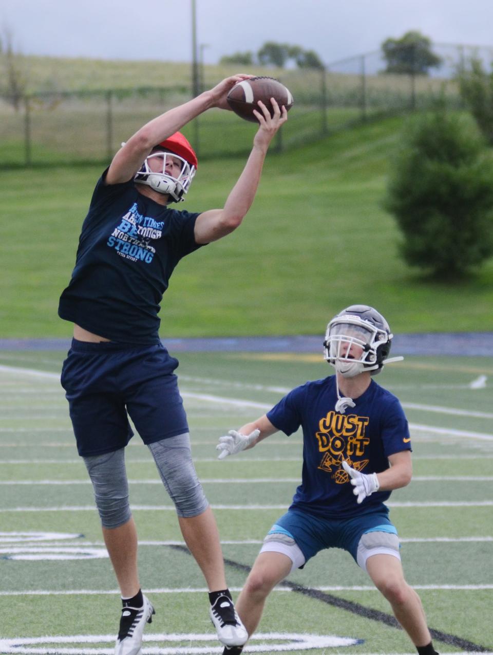 Petoskey's Luke Matelski (left) makes a leaping catch in front of Haden Janes during practice.
