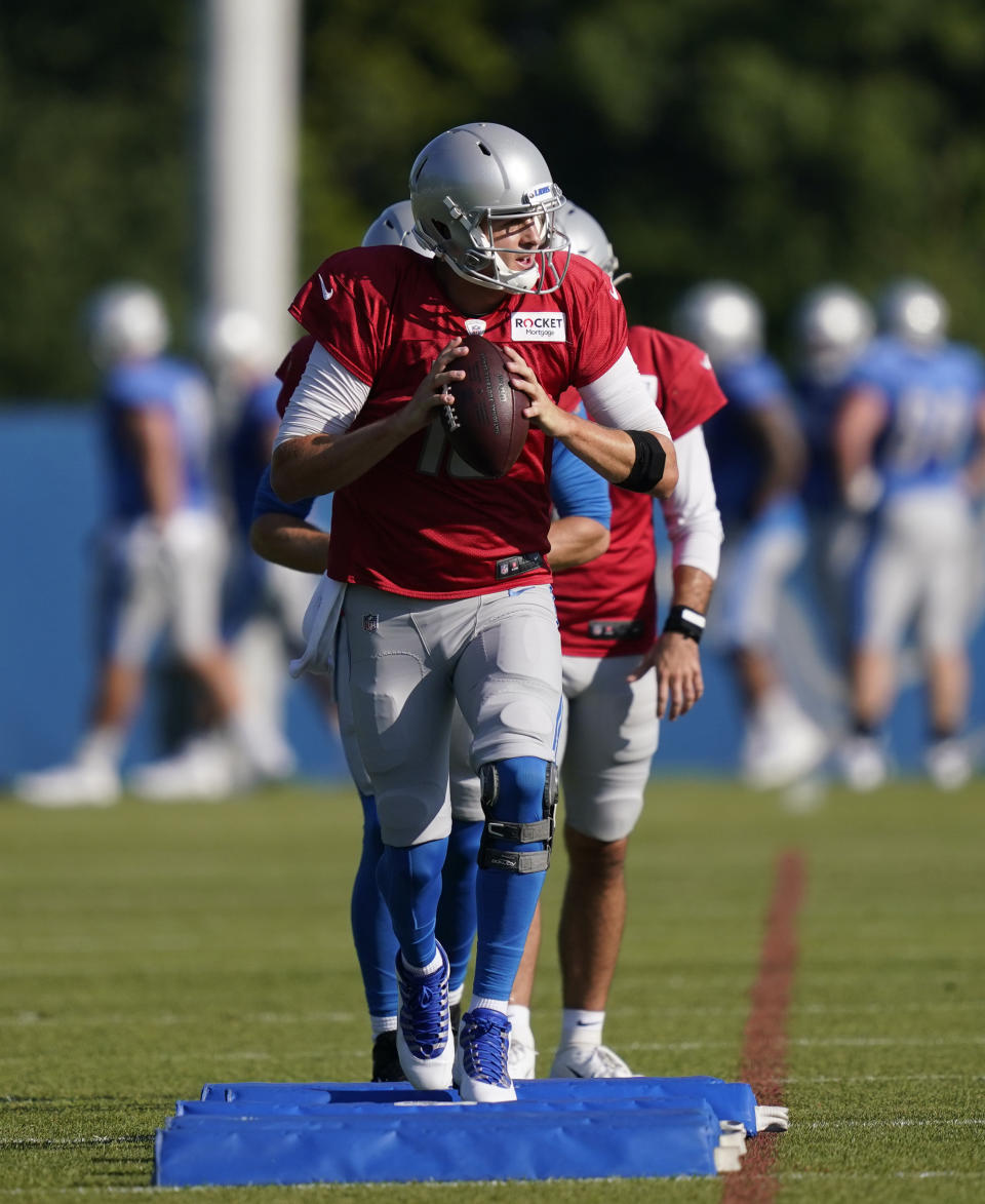 Detroit Lions quarterback Jared Goff leads Tim Boyle and David Blough in a drill at the Lions NFL football camp practice, Wednesday, Aug. 4, 2021, in Allen Park, Mich. (AP Photo/Carlos Osorio)