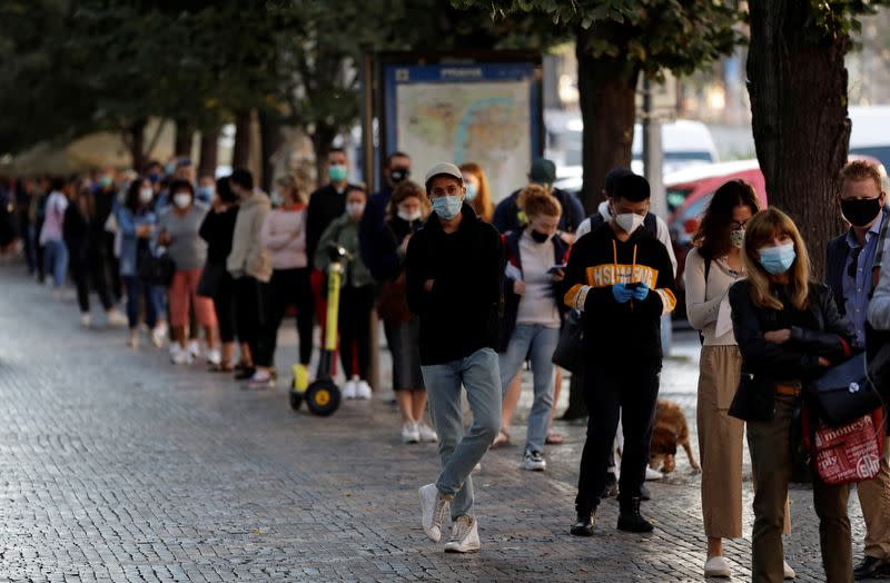 People wait in a line to get tested for the coronavirus disease in Prague