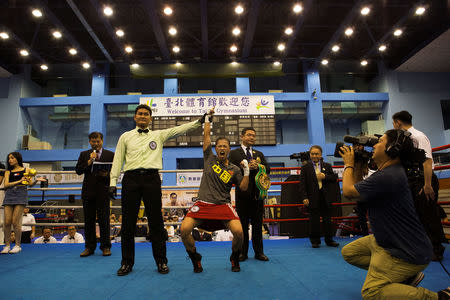 Huang Wensi celebrates her victory after the referee awards her a technical knock-out during the seventh round in her fight against Thailand's Jarusiri Rongmuang for the Asia Female Continental Super Flyweight Championship gold belt in Taipei, Taiwan, September 26, 2018. REUTERS/Yue Wu