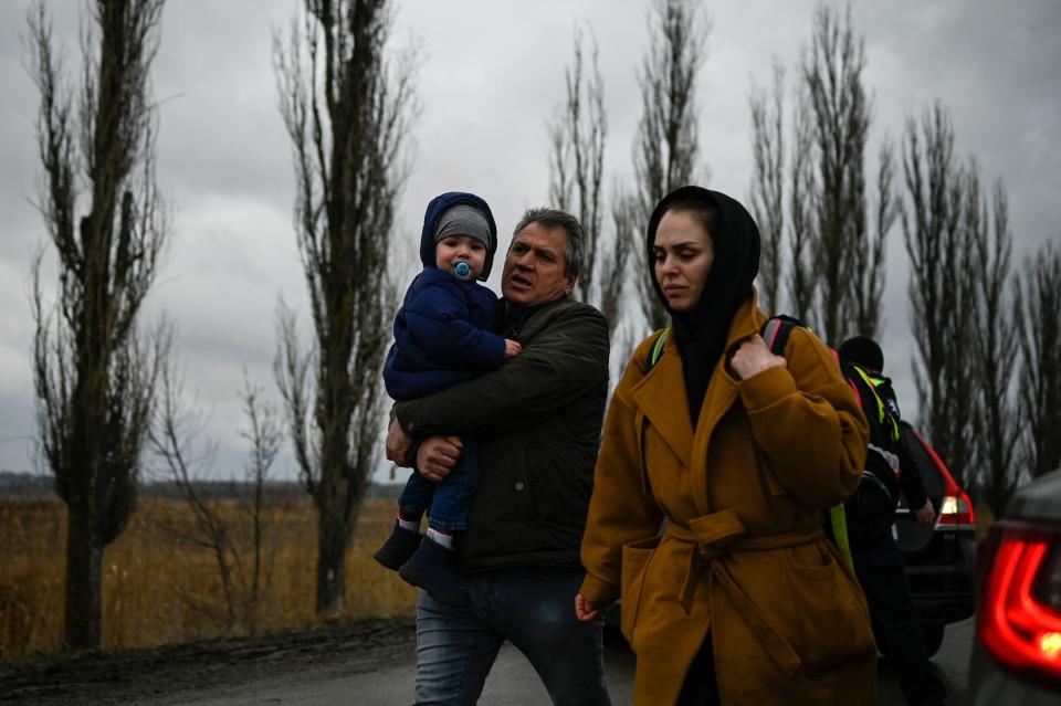 A family  fleeing the conflict in Ukraine walks after crossing the Moldova-Ukraine border checkpoint near the town of Palanca, on March 2, 2022, seven days after Russia' military invasion of Ukraine. - Nearly 875,000 people have fled Ukraine in total, the UN refugee agency said on march 2, 2022, with the number expected to rise. (Photo by Nikolay DOYCHINOV / AFP) (Photo by NIKOLAY DOYCHINOV/AFP via Getty Images)