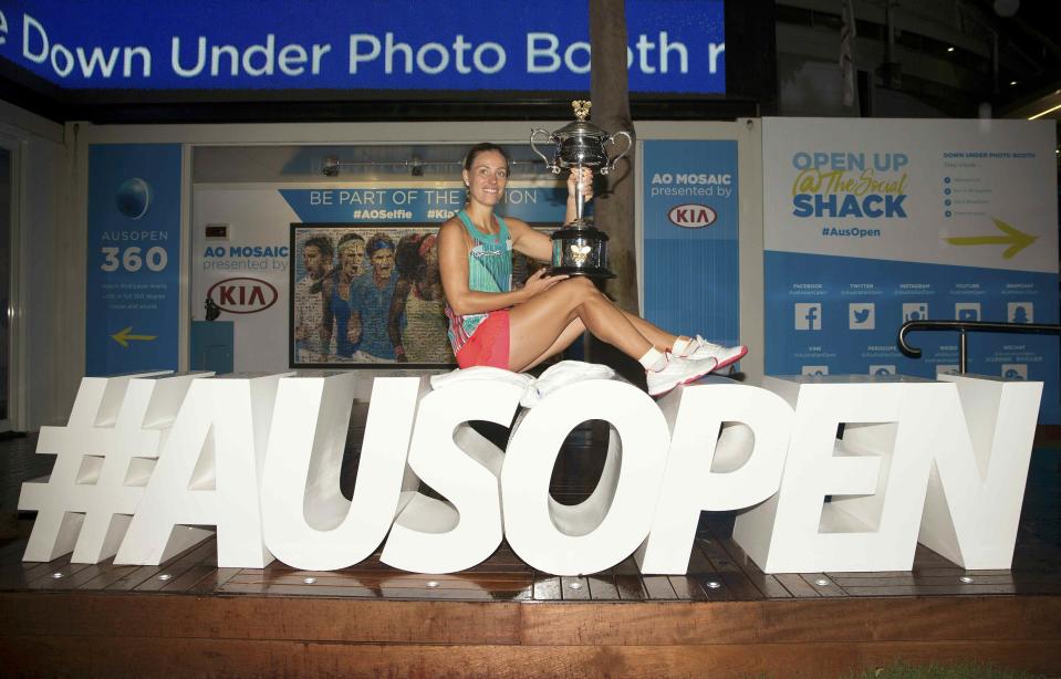 Germany's Angelique Kerber poses with the trophy after winning her final match against Serena Williams of the U.S. at the Australian Open tennis tournament at Melbourne Park, Australia, in this January 30, 2016 handout photo. REUTERS/Fiona Hamilton/Handout via ReutersATTENTION EDITORS - THIS PICTURE WAS PROVIDED BY A THIRD PARTY. THIS PICTURE IS DISTRIBUTED EXACTLY AS RECEIVED BY REUTERS, AS A SERVICE TO CLIENTS. FOR EDITORIAL USE ONLY. NOT FOR SALE FOR MARKETING OR ADVERTISING CAMPAIGNS. NO RESALES. NO ARCHIVE.