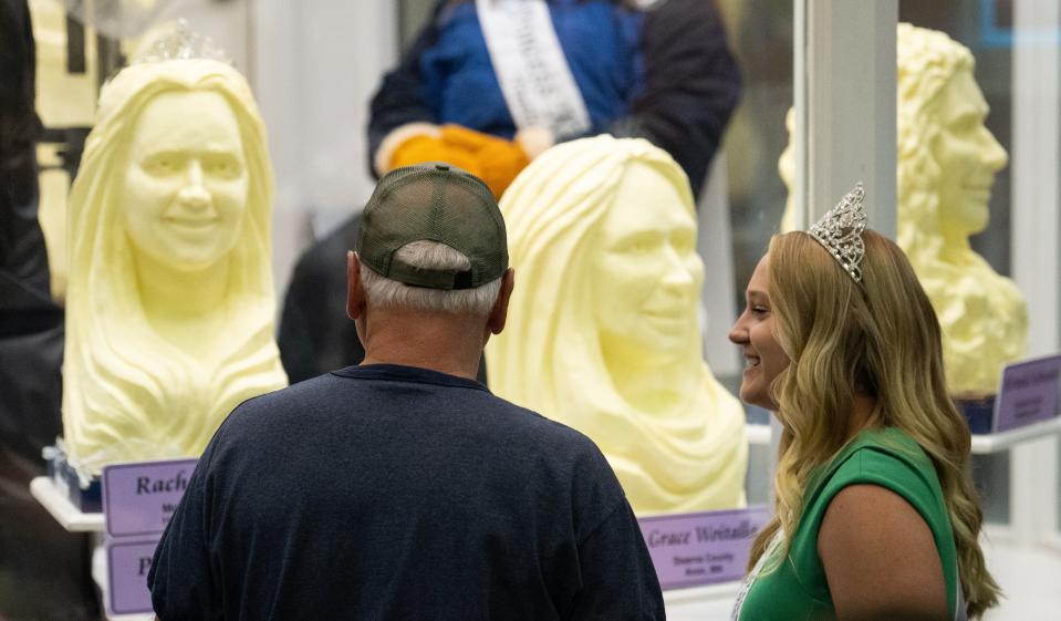 Tim Walz speaks with Rachel Visser, the 71st Princess Kay of the Milky Way, as they look at the butter sculptures (Getty Images)