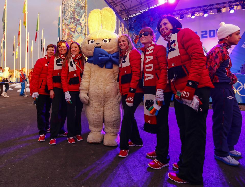 Members of Canada's Olympic Team pose with an Olympic mascot during a welcoming ceremony for the team in the Athletes Village, at the Olympic Park ahead of the 2014 Winter Olympic Games in Sochi February 5, 2014. REUTERS/Shamil Zhumatov (RUSSIA - Tags: SPORT OLYMPICS)
