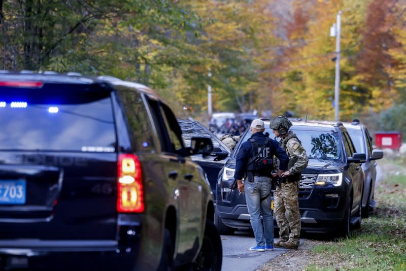 Law-enforcement officers gather near the home of mass-shooting suspect Robert Card in Bowdoin, Maine, on Thursday. Photo by C.J. Gunther/EPA-EFE