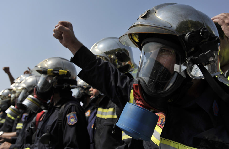 Firefighters shout slogans during a protest in the northern Greek port city of Thessaloniki, Saturday, Sept. 8, 2012. Greece, in the grip of a severe recession for the fifth straight year, is still struggling to avoid bankruptcy by imposing harsh austerity measures, including wage and pension cuts. Unemployment has soared to nearly a quarter of the workforce. (AP Photo/Nikolas Giakoumidis)