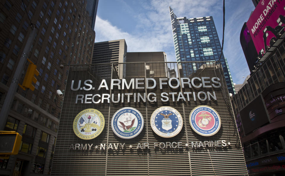 FILE - The Times Square military recruiting station displays insignia for each military branch, Friday, July 17, 2015, in New York. On Friday, Oct. 13, 2023, The Associated Press reported on stories circulating online incorrectly claiming the U.S. military is planning to reinstitute the draft.(AP Photo/Bebeto Matthews, File)