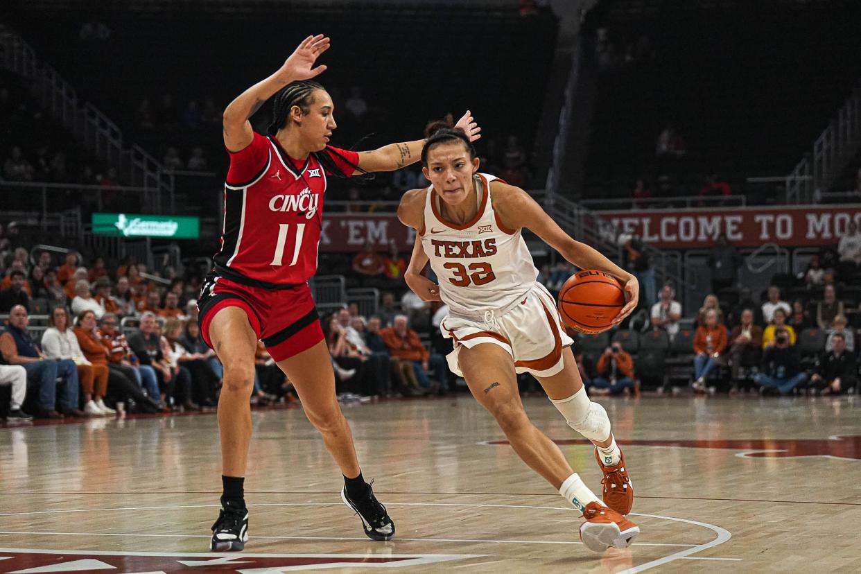 Texas Longhorns guard Ndjakalenga Mwenentanda (32) pushes past Cincinnati guard Ta'Ziah Jenks (11) during the women’s basketball game at the Moody Center on Saturday, Jan. 27, 2024 in Austin.