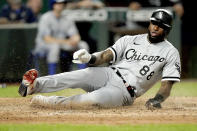 Chicago White Sox's Luis Robert slides home to score on a double by Gavin Sheets during the eighth inning of the second game of a baseball doubleheader against the Kansas City Royals Tuesday, Aug. 9, 2022, in Kansas City, Mo. (AP Photo/Charlie Riedel)