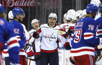 Garnet Hathaway, center, of the Washington Capitals celebrates his second-period goal against the New York Rangers during an NHL hockey game Monday, May 3, 2021, in New York. (Bruce Bennett/Pool Photo via AP)