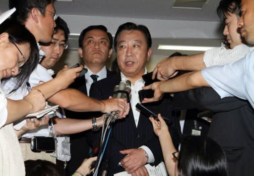Japanese Finance Minister Yoshihiko Noda (pictured) speaks to reporters after G7 financial chiefs and central bankers agreed to cooperate against excessive currency moves at his office in Tokyo