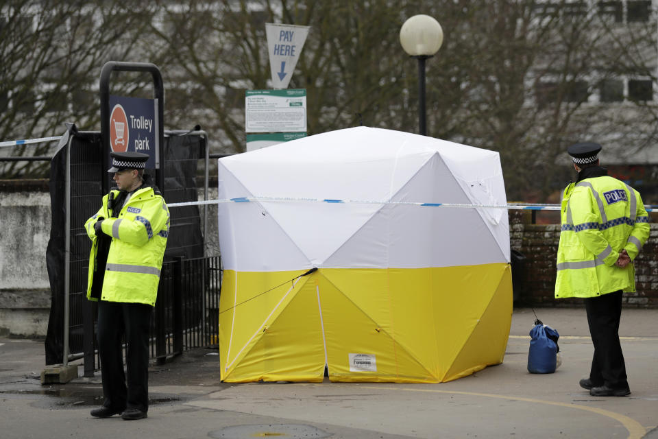 FILE - Police officers guard a supermarket parking facility near where former spy and defector Sergei Skripal and his daughter were found critically ill following exposure to the Russian-developed nerve agent Novichok in Salisbury, England, on Tuesday, March 13, 2018. The British government accused Russia of attempted murder in the poisonings. Two men identified by authorities as carrying out the attack denied any involvement and told Russian television they were simply tourists. (AP Photo/Matt Dunham, File)