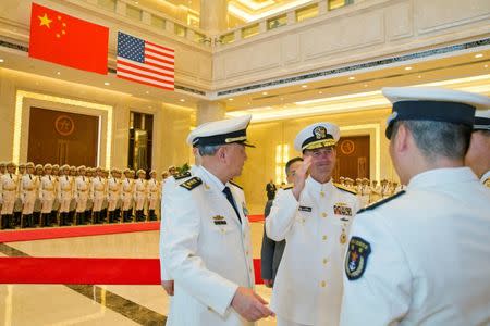 Commander of the Chinese navy, Admiral Wu Shengli (L) introduces his officers to U.S. Chief of Naval Operations Admiral John Richardson (2nd, L) during a welcome ceremony held at the Chinese Navy Headquarters in Beijing, China, July 18, 2016. REUTERS/Ng Han Guan/Pool