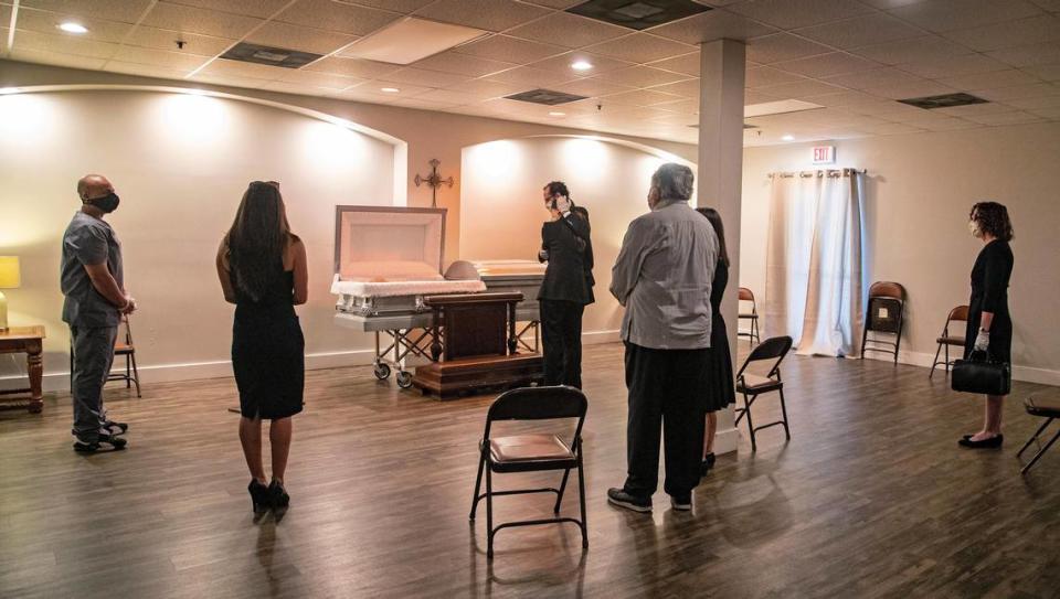 The Humberto Alonso family practices social distancing as they gather for a final farewell at Vior Funeral Home on Wednesday, April 22, 2020. Due to COVID-19, viewings are now limited to ten people.