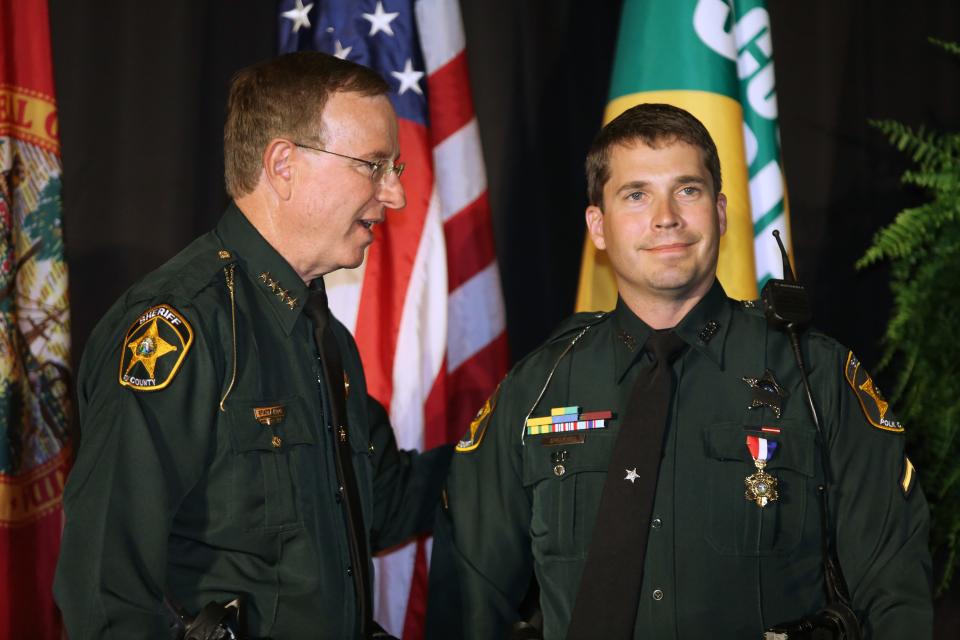 Polk County Sheriff Grady Judd, left, presents Deputy Sean Speakman with the Medal of Honor during the 2013 Polk County Sheriff's Office Annual Awards Ceremony.