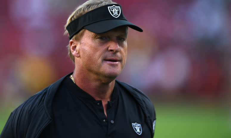 A closeup of Oakland Raiders coach Jon Gruden wearing a black visor.