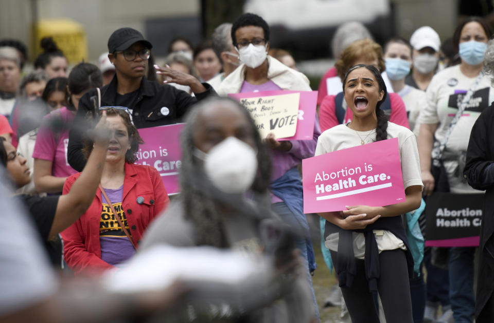 Chandler Jones, right, 26, from Baltimore County who will graduate this spring from the University of Baltimore School of Law, participates in a pro-choice rally in Baltimore, Saturday, May 14, 2022. Jones consulted the internet on her cellphone for information and advice before having an abortion during her junior year in college. In a post-Roe world, if the Supreme Court soon reverses the 1973 decision that legalized abortion, as a draft opinion suggests it may, pregnancies could be surveilled and the data shared with police or sold to vigilantes. (AP Photo/Steve Ruark)