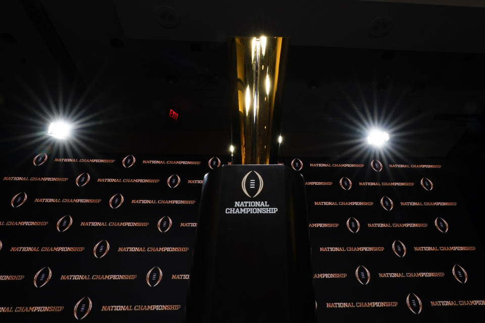 The trophy is displayed before a news conference for the NCAA College Football Playoff national championship game Sunday, Jan. 12, 2020, in New Orleans. Clemson is scheduled to play LSU on Monday. (AP Photo/David J. Phillip).