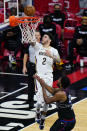 New Orleans Pelicans' Lonzo Ball, left, goes up for a shot against Philadelphia 76ers' Joel Embiid during the second half of an NBA basketball game, Friday, May 7, 2021, in Philadelphia. (AP Photo/Matt Slocum)