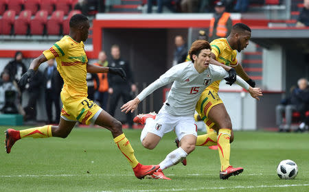 Soccer Football - International Friendly - Kirin Challenge Cup 2018 - Japan vs Mali - Stadium Maurice Dufrasne, Liege, Belgium - March 23, 2018 Japan’s Yuya Osako in action with Mali’s Molla Wague REUTERS/Eric Vidal