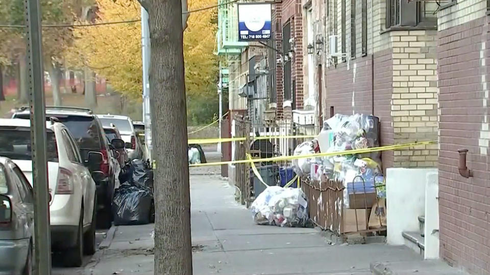 The area outside the building in the Bronx where the babies were found is seen to be blocked off with police tape