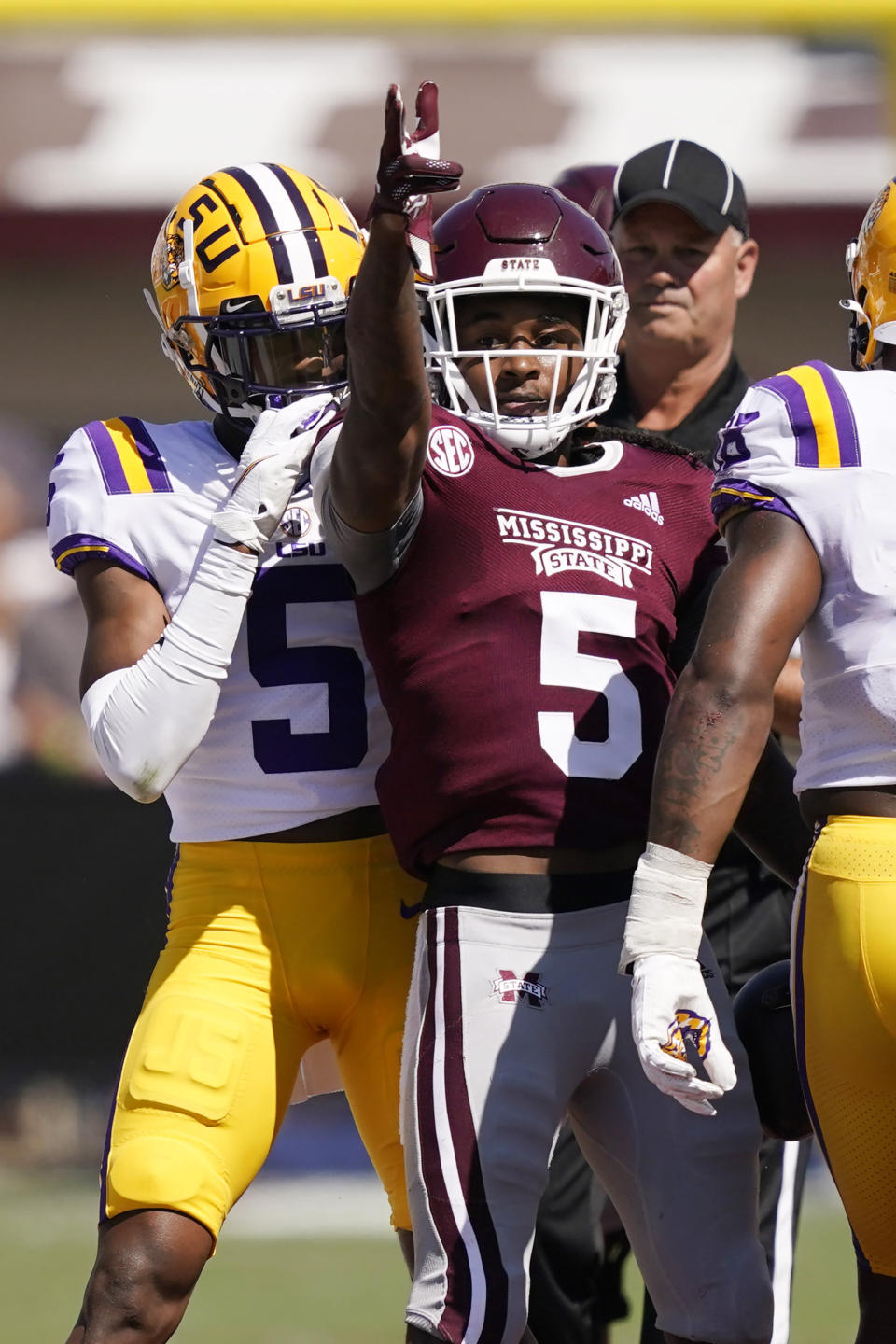 Mississippi State wide receiver Lideatrick Griffin (5) stands amid LSU defenders and gestures after catching a pass for a first down during the first half of an NCAA college football game, Saturday, Sept. 25, 2021, in Starkville, Miss. (AP Photo/Rogelio V. Solis)