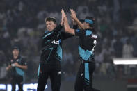 New Zealand's Michael Bracewell, center, celebrates with teammate after taking the wicket of Pakistan's Shadab Khan during the fourth T20 international cricket match between Pakistan and New Zealand, in Lahore, Pakistan, Thursday, April 25, 2024. (AP Photo/K.M. Chaudary)