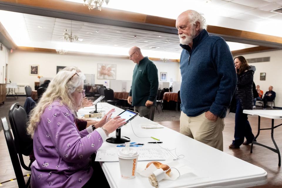 Rob Baldi, right, of Doylestown Township, checks in with majority inspector Rachel Robinson before voting at the Central Bucks Senior Center, in Doylestown Township, during the General Election on Tuesday, Novemeber 7, 2023.