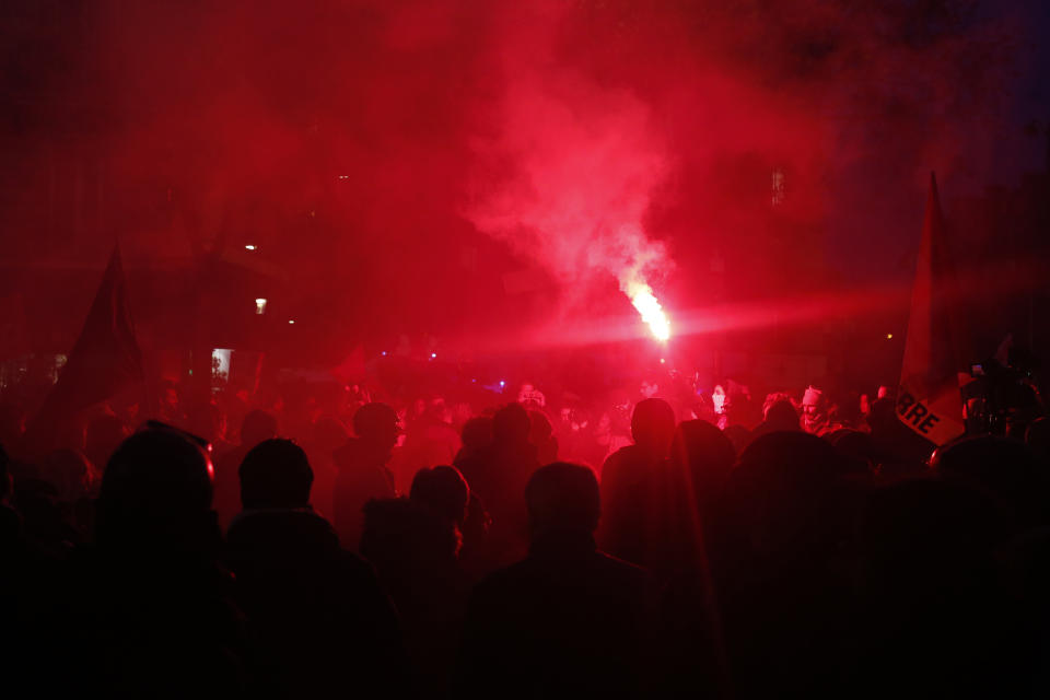 Protesters use flares during a demonstration Tuesday, Dec. 10, 2019 in Paris. French airport employees, teachers and other workers joined nationwide strikes Tuesday as unions cranked up pressure on the government to scrap upcoming changes to the country's national retirement system. (AP Photo/Thibault Camus)