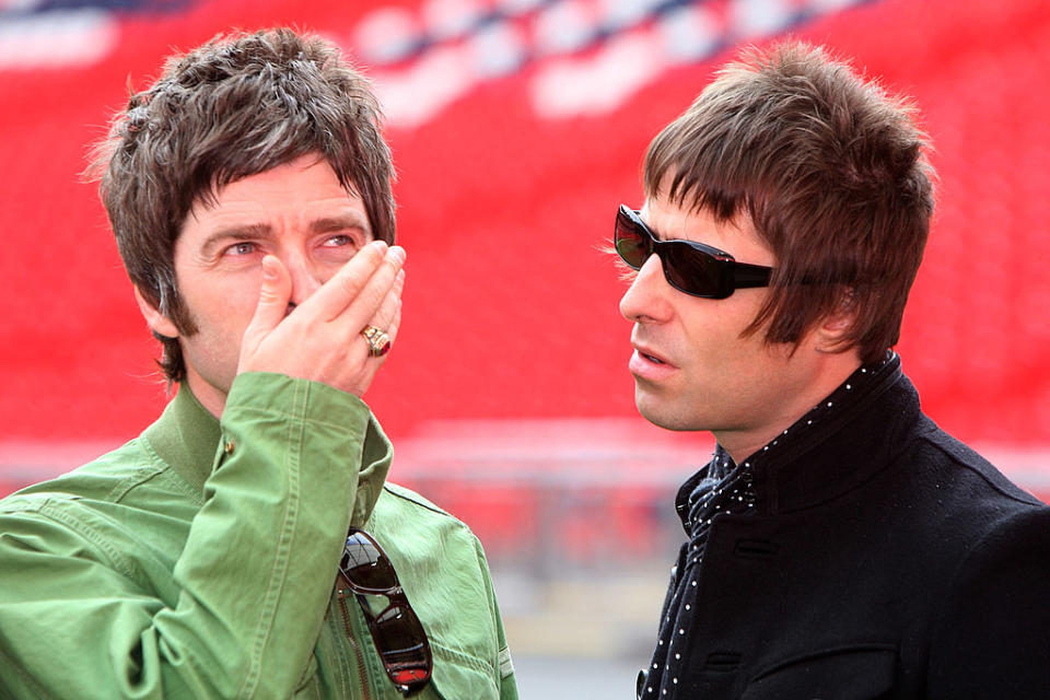 Liam and Noel posing together in jackets