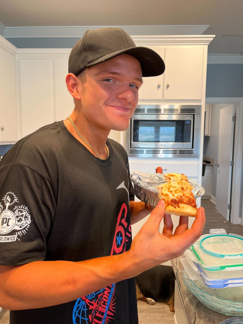 After intense dieting, Richard Dana enjoys his first bite of pizza post competition last year. He said that “it tasted better than anything I’ve eaten before.” | Courtesy of Richard Dana
