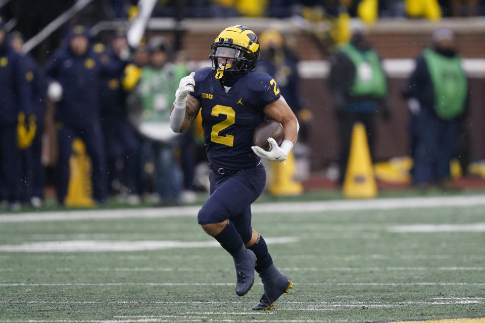 Michigan running back Blake Corum rushes during the second half of an NCAA college football game against Ohio State, Saturday, Nov. 27, 2021, in Ann Arbor, Mich. (AP Photo/Carlos Osorio)