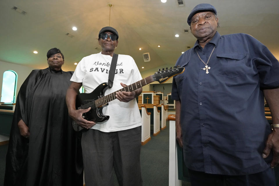 Siblings Annie Brown Caldwell, left, R.C. Brown, center, and Edward Brown, original members of the Staple Jr. Singers, gather in their home church of Johnson Chapel Holiness Church in Aberdeen, Miss., May 20, 2024, for a group photograph. (AP Photo/Rogelio V. Solis)