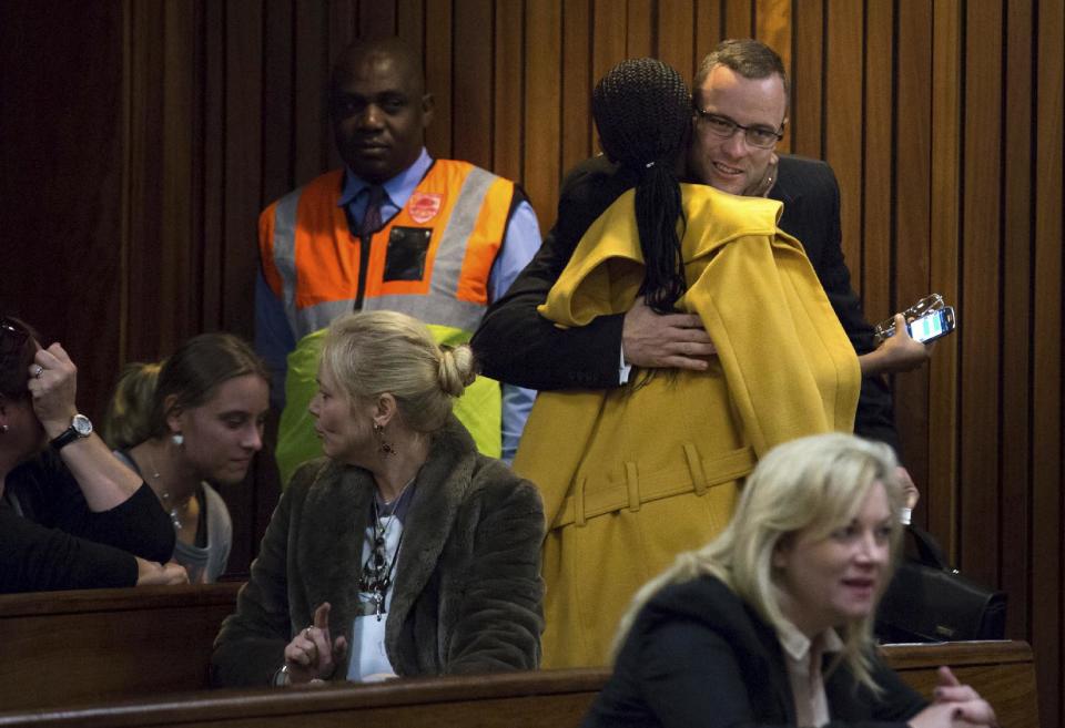 Oscar Pistorius, top right, is greeted by a supporter on his arrival in court for his ongoing murder trial in Pretoria, South Africa, Tuesday, May 13, 2014. Pistorius is charged with the shooting death of his girlfriend Reeva Steenkamp on Valentine's Day in 2013. (AP Photo/Daniel Born, Pool)
