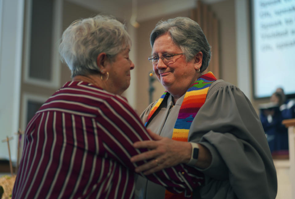 The Rev. Linda Barnes Popham, right, prays with a member of Fern Creek Baptist Church during a service, Sunday, May 21, 2023, in Louisville, Ky. In February, Fern Creek was one of five churches disfellowshipped from the Southern Baptist Convention because they have female pastors. But Fern Creek and Saddleback Church of California have decided to appeal. The challenge will be voted on at the upcoming SBC annual meeting. (AP Photo/Jessie Wardarski)