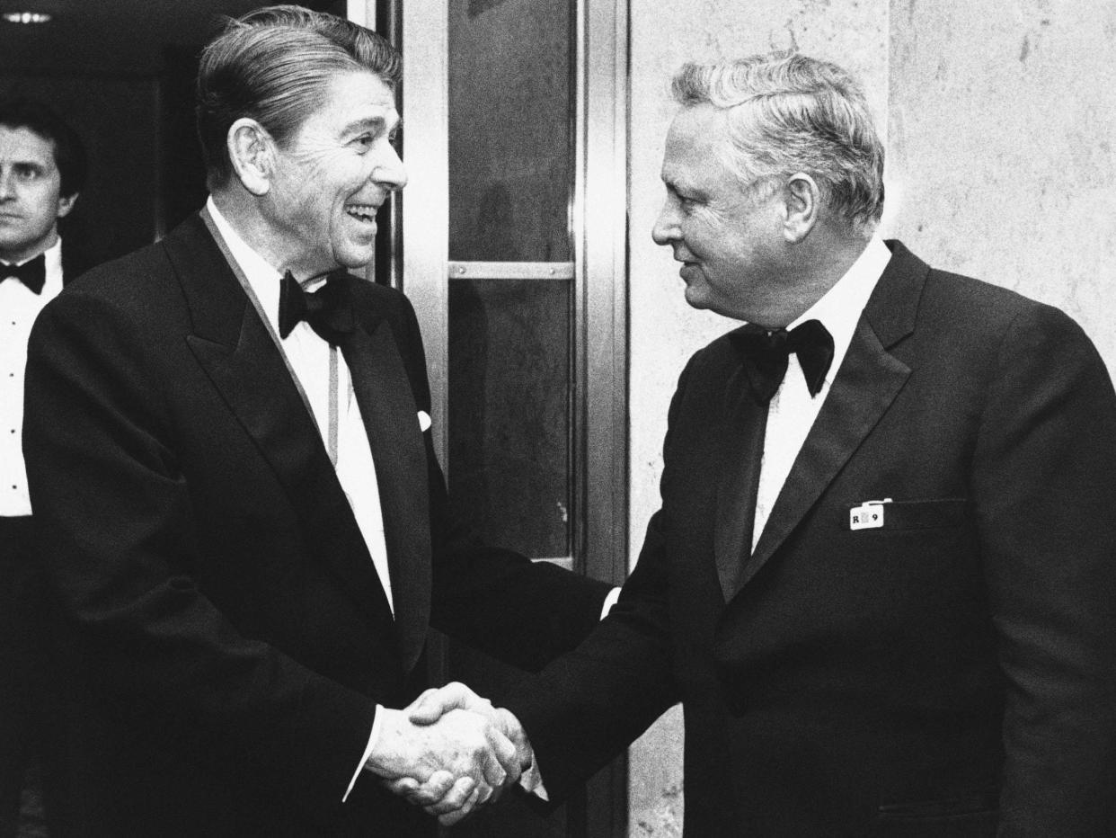 Ronald Reagan (left) shakes hands with Hilton upon his arrival at Capitol Hill in 1985: AP